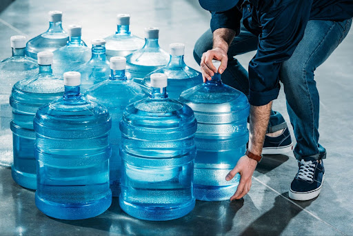 Man delivering large bottles of drinking water in Michigan