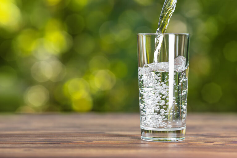 Clean filtered well water being poured into a glass